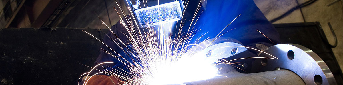 Industrial arc welder at work