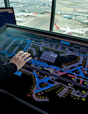 Air traffic controller's hand on ramp departure console.