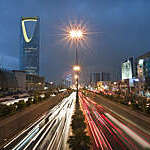View of red and white light trails as cars stream up and down King Fahad Road in Riyadh, Saudi Arabia.