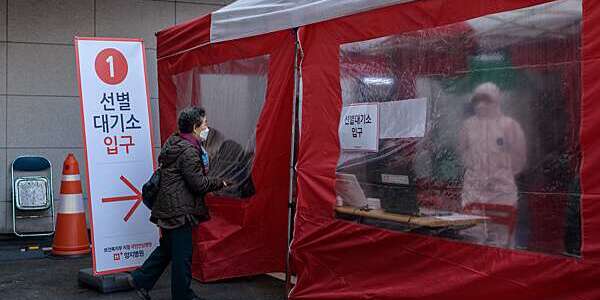 An elderly woman enters a coronavirus testing booth outside the Yangji Hospital in Seoul, South Korea.