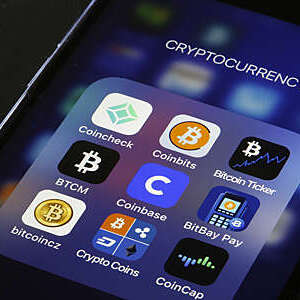 Close-up of smartphone screen displaying cryptocurrency apps.