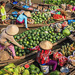 Vietnamese women selling and buying fruits on floating market, Mekong River Delta, Vietnam